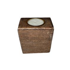 a small wooden box with a candle inside