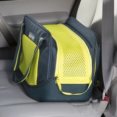 the back end of a car seat with a yellow bag on it's side