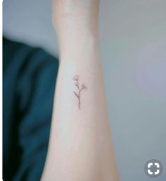 a small flower tattoo on the wrist