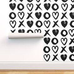 black and white wallpaper with hearts and xo symbols on it in an empty room