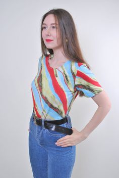 "Abstract print women holiday multicolor tshirt for festival, Size M Welcome to TARASCOMMON.ETSY.COM Unique clothing from the 20th century. Model tall - 170cm M. Sleeve - 8cm / 3.14inch; ( armpit to end of sleeve); Width - 40cm / 15.74inch; Length - 55cm / 21.65inch. All measurements are taken seam to seam while lying flat. Viscose. This item is vintage, so it can have some defects. Additional photos can be send We are glad that you are interested in lots that we sell. Wish you a good shopping! Purple Bag, Minimalist Women, Unique Clothing, The 20th Century, Star Shirt, Unique Outfits, Blouse Vintage, Abstract Print, Tie Dye Top