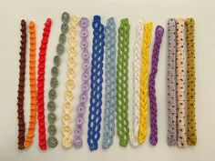 there are many crocheted ties lined up together