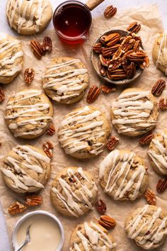 a table topped with cookies covered in frosting and pecans