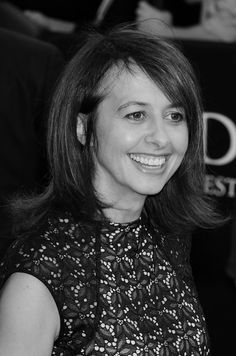 a black and white photo of a woman smiling