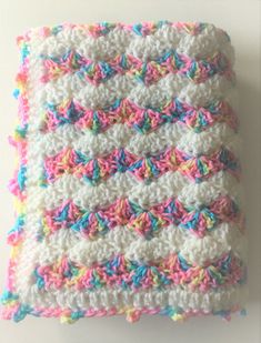 a crocheted square with multicolored yarn