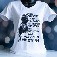 "Empower yourself or the women in your life with this beautiful tee! This shirt features a woman's striking stare and an inspiring quote - \"They whispered to her you cannot handle the storm. She whispered back I am the storm.\" I have had some really difficult years lately and felt so empowered by this design! I wanted to make sure to pair it with an equally strong font to give her message some additional fierceness. Empower yourself or the queens in your life by treating them to this inspiring They Whispered To Her You Cannot, Shirt Quotes Inspirational, Plus Size Shirts For Women, She Whispered, Strong Font, Gifts For Best Friend, Children Quotes, Girl Trip, I Am The Storm