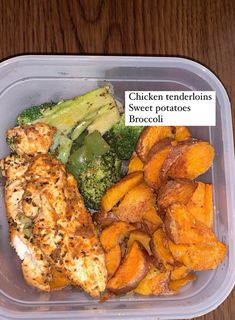 a plastic container filled with chicken, sweet potatoes and broccoli on top of a wooden table