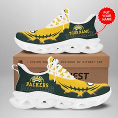 two green bay packers sneakers on top of a cardboard box with the tag your name