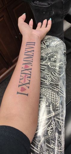 a person with a tattoo on their arm that reads, i love my mommy mary