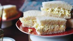 three pieces of cake sitting on top of a red plate next to a cup and saucer