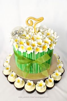 a green and white cupcake decorated with flowers