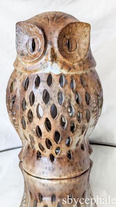 an owl statue sitting on top of a table