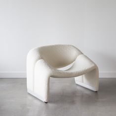 a white chair sitting on top of a cement floor