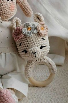 a crocheted stuffed animal holding a ring