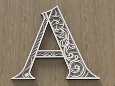 the letter a is made up of intricately designed metal letters with swirly designs on them