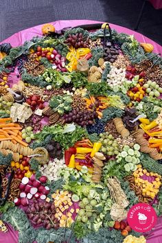 a large platter filled with lots of different types of fruits and vegetables