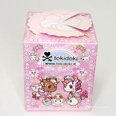 a pink box with two cats on the front and one cat on the back that says tokidoki