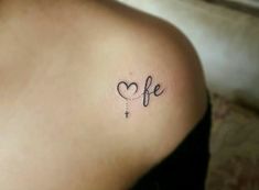 a small tattoo on the back of a woman's shoulder that reads, life