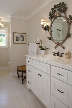 a bathroom with two sinks and a large mirror on the wall above it's counter