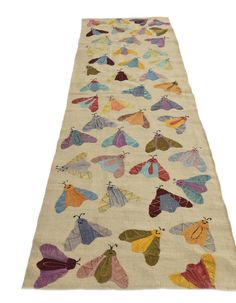 a long rug with colorful moths on it