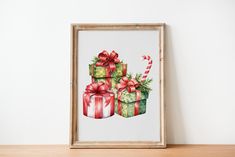 a painting of presents with candy canes and bows on them in front of a white wall