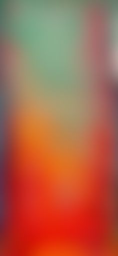 an abstract blurry background with red, orange and green colors