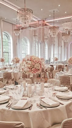 the tables are set with white linens and pink flowers