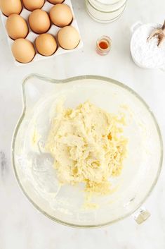 eggs, butter and flour in a bowl on a counter top next to other ingredients