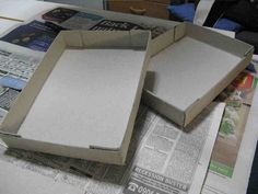 two open boxes sitting on top of a newspaper