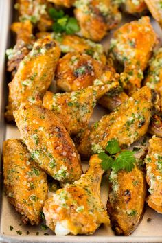 garlic parmesan chicken wings in a pan with herbs on top and the title overlay reads garlic parmesan chicken wings