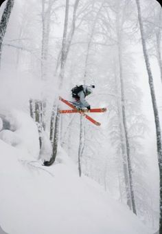 a man flying through the air while riding skis