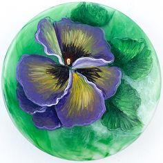 a painting of a purple flower with green leaves on the bottom and yellow center in the middle