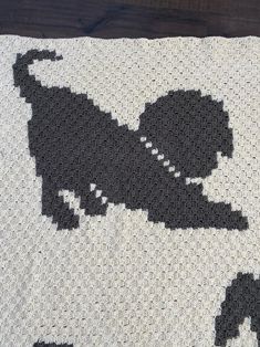 a black and white crocheted blanket with an elephant on it