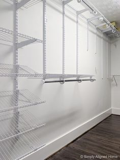 an empty room with shelving and shelves on the wall next to a wood floor