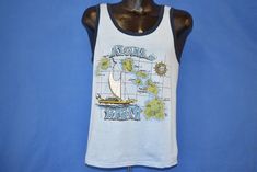 Chest 19.5 in.Length 21.5 in. Tag Says: Unreadable brand, 50/50This blue tourist tank top has a graphic of the Hawaiian islands, including Hawaii, Maui, Lanai, and Oahu. Hawaii is a cluster of volcanic islands in the Pacific Ocean. It is the 50th state of America, and gained statehood in 1959.Comments: Fits like a modern unisex adult medium, repair on back, see pics   19-04-94194 Aloha Hawaii, Hawaii Island, Hawaiian Islands, Star Shirt, Pacific Ocean, Oahu, Graphic Tank Top, Hawaii, Graphic Tees