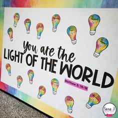 a sign that says, you are the light of the world with colorful lights on it