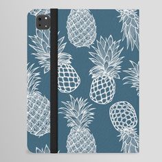 a blue notebook with white pineapples on it