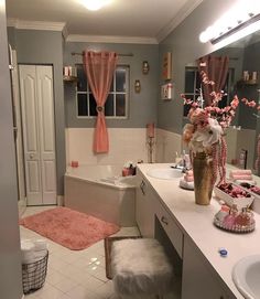 the bathroom is decorated in pink and gray