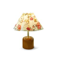 a table lamp with a flowered shade on it's base and wooden base