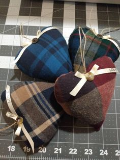 three heart shaped cushions sitting on top of a cutting board