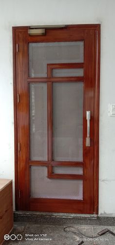 an empty room with a wooden door and sidelight on the wall, in front of a window