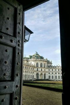 an open door leading to a large white building