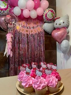 a hello kitty birthday party with cupcakes and balloons