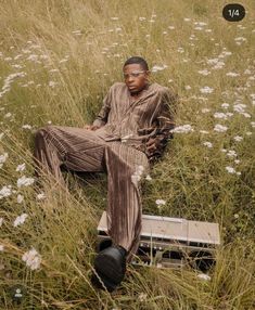 a man sitting in the middle of a field