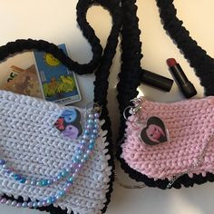 two crocheted purses sitting next to each other