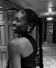 a woman with long hair standing in an elevator