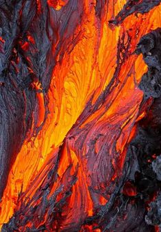 close up view of the lava inside an open fire pit with bright orange and black colors