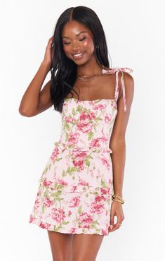 Get swept away by romance in the Lady Corset Mini. Beautiful tiers of pink florals fall to a mini hem topped with a figure flattering corset bodice that can be tightened as you please! Let her be the statement of your look paired with dainty jewelry and barely there heels. Feminine Pink Dress With Corset Back, Pink Feminine Mini Dress With Corset Back, Pink Mini Dress With Sweetheart Neckline And Ruffle Hem, Feminine Mini Dress With Corset Back For Brunch, Pink Corset Back Dress For Garden Party, Feminine Mini Dress With Ruffle Hem And Fitted Bodice, Fitted Feminine Tiered Mini Dress, Feminine Fitted Tiered Mini Dress, Pink Tiered Mini Dress For Garden Party