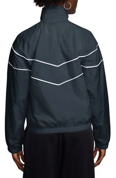 The wind and rain won't slow you down in this sleek jacket made from durable, water-repellent ripstop fabric. The breathable mesh lining and logo-branded chest make this a key piece for all your outdoor activities. Front zip closure Stand collar Elastic cuffs Front slant pockets Elastic waist Lined 100% nylon Machine wash, line dry Imported Nike Windrunner, Blusas T Shirts, Water Repellent Jacket, Wind And Rain, Chevron Design, Ripstop Fabric, Track Jackets, Navy White, The Wind