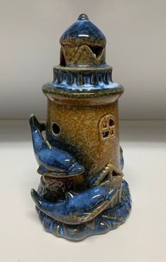 a blue and brown vase sitting on top of a table